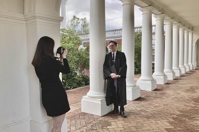 Winston Tang's friend Tim poses in his cap and gown.